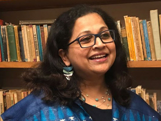 photo of Leela Prasad with bookcase background
